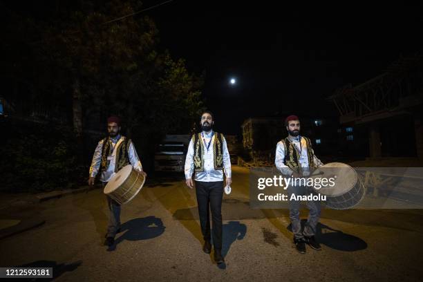 Sufi music soloist Eren Coskun and drummers Haydar Kocadere and Emir Cosan perform sufi music to wake people for 'sahur' meal, the last meal before a...