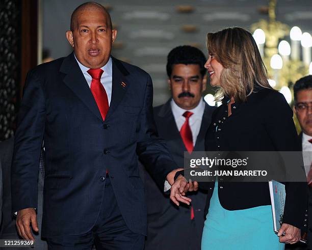 Venezuelan President Hugo Chavez walks with the South American Union of Nations Secretary General, Colombian Maria Emma Mejia , followed by...