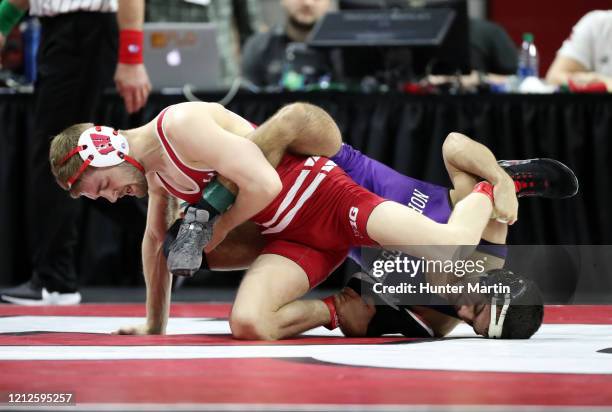 Seth Gross of the Wisconsin Badgers wrestles Sebastian Rivera of the Northwestern Wildcats during the Big Ten Championships at Rutgers Athletic...
