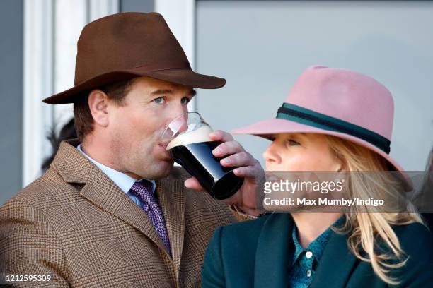 Peter Phillips and Autumn Phillips watch the racing as they attend day 4 'Gold Cup Day' of the Cheltenham Festival 2020 at Cheltenham Racecourse on...
