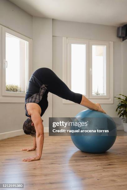 mature woman practicing pilates with fitness ball - fitness ball stock pictures, royalty-free photos & images