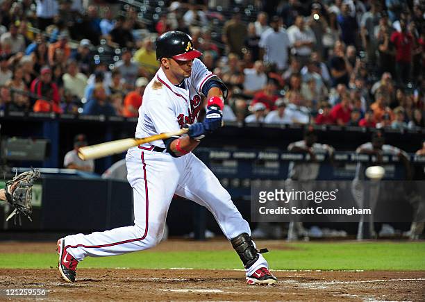Martin Prado of the Atlanta Braves singles in the 11th inning to knock in the game-winning run against the San Francisco Giants at Turner Field on...