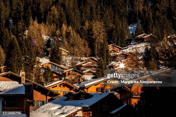 wooden cottages with their roofs covered in snow in verbier - verbier ストックフォトと画像