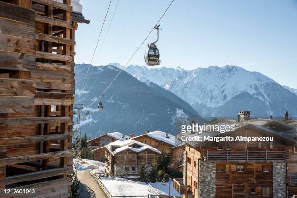 ski lifts at the alpine village of verbier during the winter season - zwitserse cultuur stockfoto's en -beelden