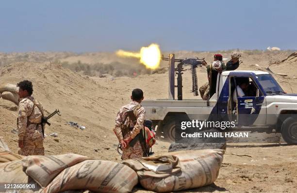 Fighters from of the Southern Transitional Council fire towards the positions of Saudi-backed government forces during clashes in the Sheikh Salim...