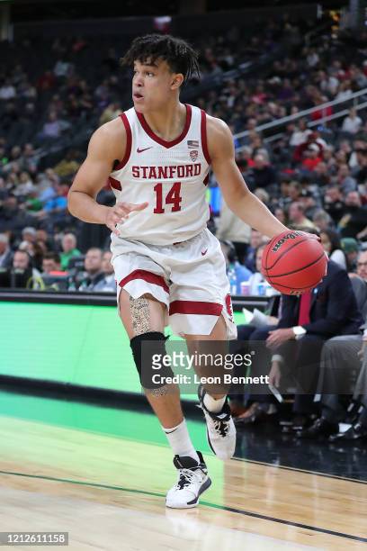 Spencer Jones of the Stanford Cardinal handles the ball against the California Golden Bears during the first round of the Pac-12 Conference...