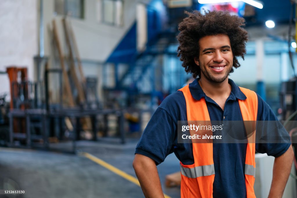 Portrait of happy young warehouse worker