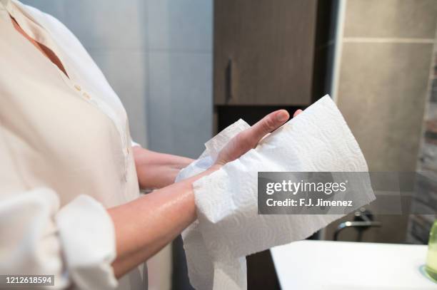 close-up of woman drying her hands with paper - asciugare foto e immagini stock