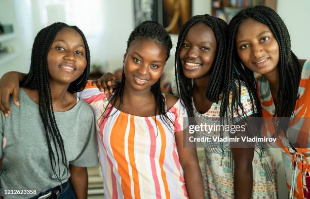 quatre amies embrassant et prenant le selfie - guinea people photos et images de collection