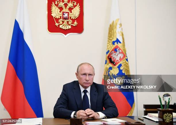 Russian President Vladimir Putin addresses the nation via teleconference at the Novo-Ogaryovo state residence outside Moscow on May 11, 2020. -...