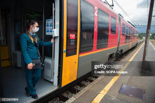 Train conductor looks on while wearing a face mask as a preventive measure as public transportation resumes in Slovenia. Public transport in Slovenia...