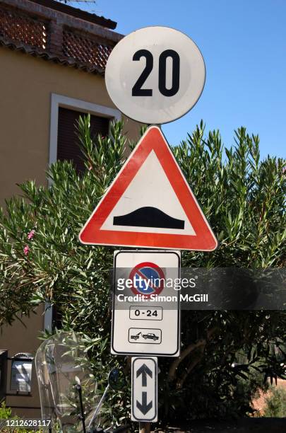 traffic signs warning of a 20 kilometre per hour speed limit sign, speed bumps ahead, a 24 hour no parking policy and towaway zone - speed bump stock pictures, royalty-free photos & images