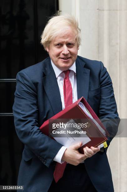 British Prime Minister Boris Johnson leaves 10 Downing Street for the House of Commons to deliver a statement on his three-stage plan for easing...
