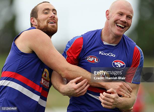 Barry Hall and Ben Hudson laugh during a Western Bulldogs AFL training session at Whitten Oval on August 17, 2011 in Melbourne, Australia.