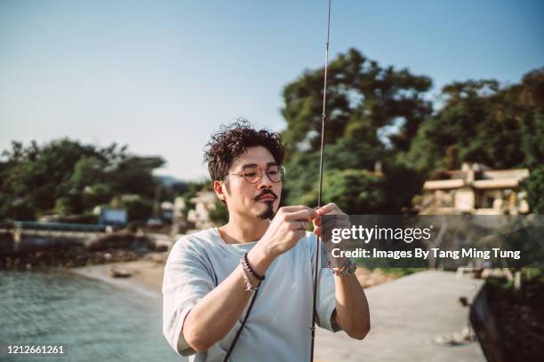 asian man prepare fishing at pier - fishing line stock pictures, royalty-free photos & images