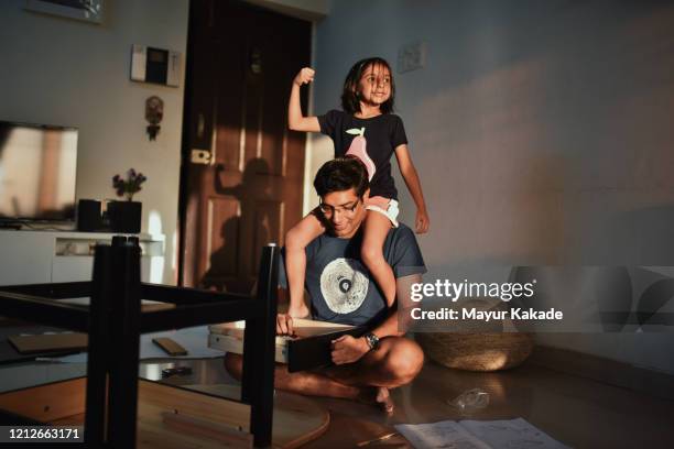 father and daughter having fun while assembling furniture - family time stock pictures, royalty-free photos & images