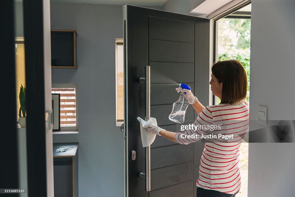 Woman cleaning front door