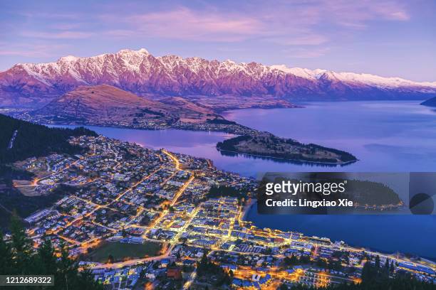 aerial view of queenstown at dusk with lake wakatipu and the remarkables, new zealand - new zealand stock pictures, royalty-free photos & images