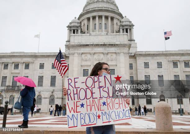 Protester stands outside of the Rhode Island State House calling for Rhode Island to reopen on May 11, 2020 in Providence, RI. Governor Gina Raimondo...