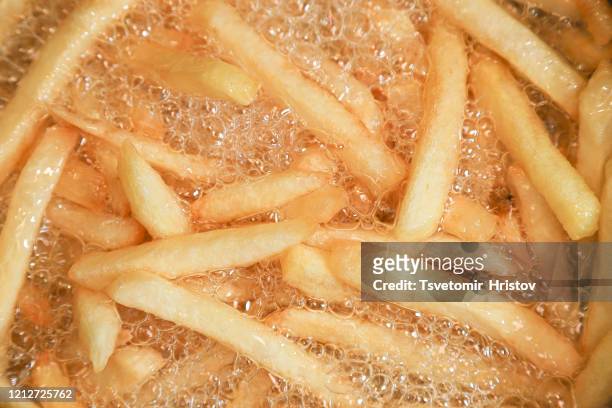 cooking french fries. - fast food french fries - fotografias e filmes do acervo