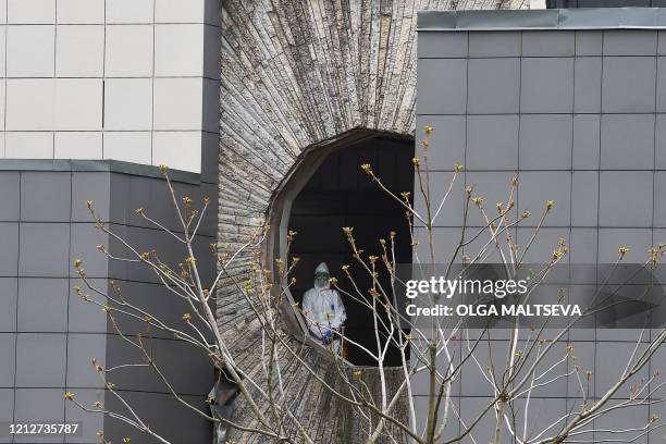 Medic wearing protective gear is seen in the premises of the Saint George hospital after a fire broke out in the medical facility in Saint Petersburg...