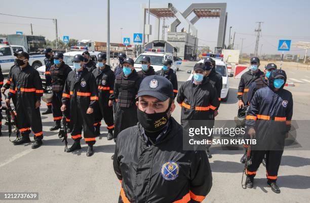 Security forces loyal Gaza's Islamist rulers Hamas, dressed in personal protective equipment as a precaution due to the COVID-19 coronavirus...