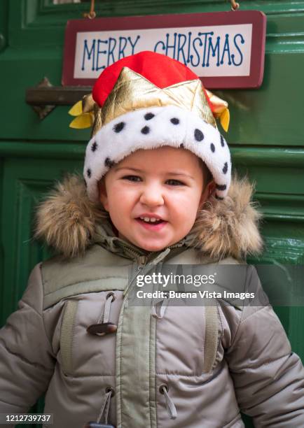 smiling baby boy under christmas sign - traditional parka stock pictures, royalty-free photos & images