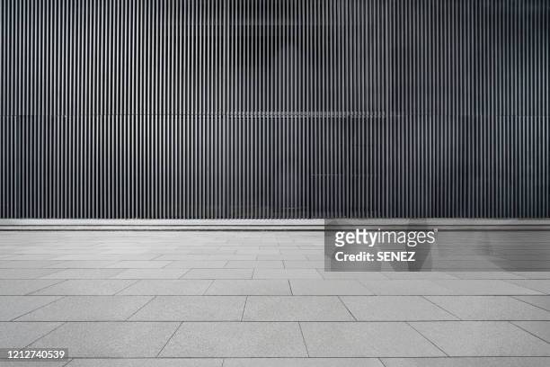 empty futuristic architecture with gray floors and silver metal line wall - wide stock-fotos und bilder