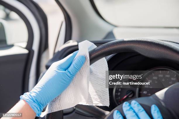 hands with glove wiping car steering wheel. - disinfection stock pictures, royalty-free photos & images