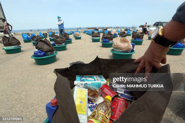 Plastic bowls with aid items are pictured at a United Nations' High Commissioner for Refugees camp for displaced Libyans and asylum seekers, on May...