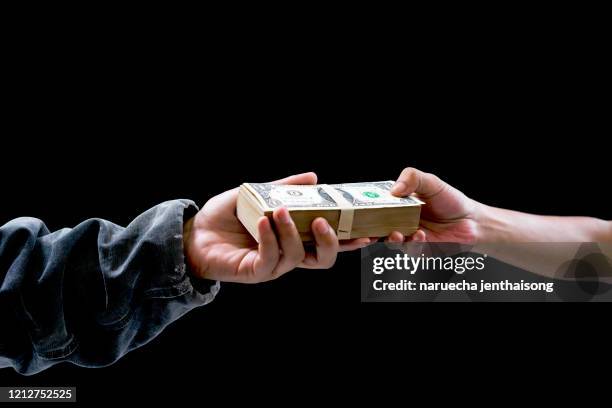 sending money from one hand to another. some pay money for trading,buy something , exchanging or sending fraudulent money, corruption. - money borrow stockfoto's en -beelden