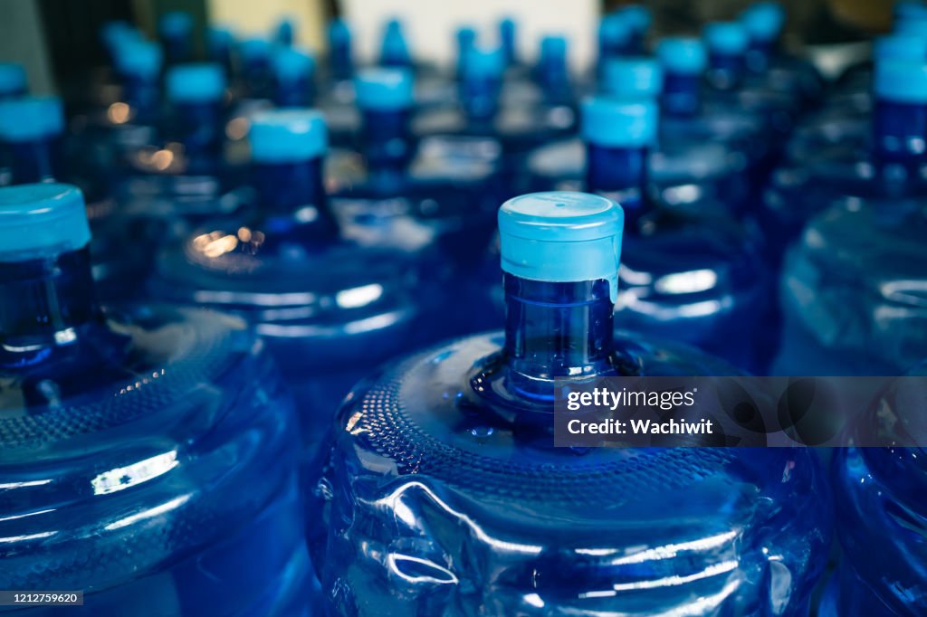 A pile of large drinking water bottles
