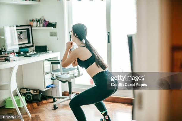 doing exercise at home - home workout stock pictures, royalty-free photos & images