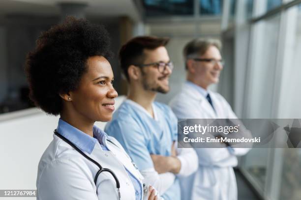 shot of three medical practitioners standing together - doctor authority stock pictures, royalty-free photos & images