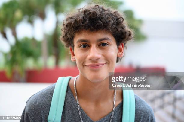 portrait of contented male hispanic teenager - boys stock pictures, royalty-free photos & images