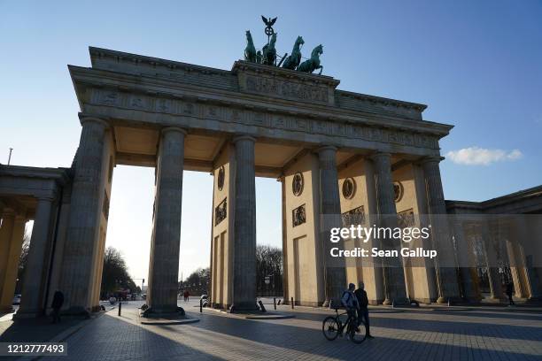 The Brandenburg Gate, a popular landmark and tourist destination, stands nearly devoid of visitors on March 16 in Berlin, Germany. Everyday life in...