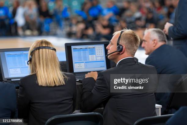 basketball commentators using laptops - commentator imagens e fotografias de stock