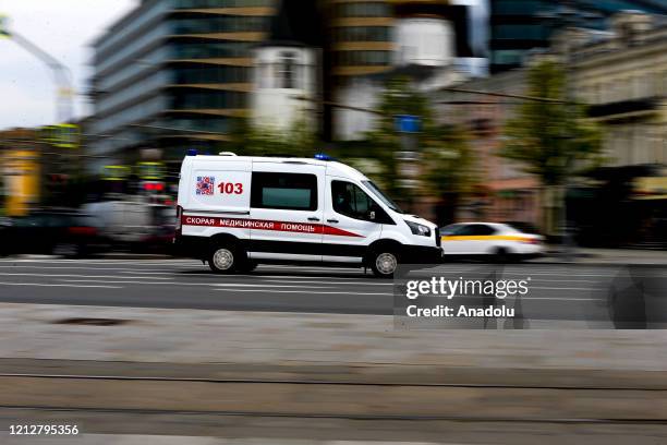An ambulance is seen in a street as the coronavirus death toll has reached to 2,116 with 232,243 confirmed cases in Moscow, Russia on May 12, 2020.