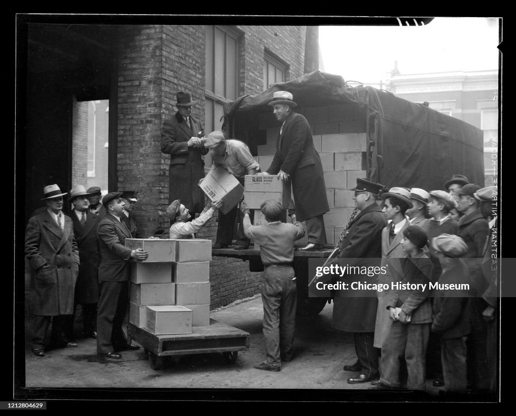 Men Unloading Boxes From A Truck