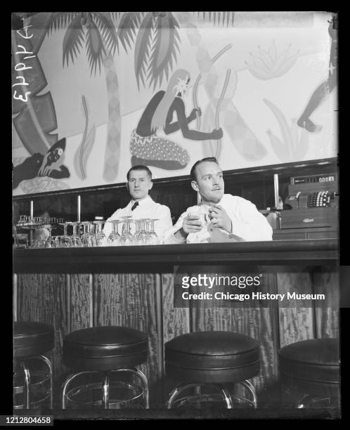 Bartenders preparing for crowds during the repeal of prohibition at the Palmer House Bar, featuring a Balinese scene mural painted by Honore Palmer...