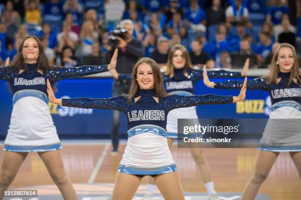 cheerleaders performing in basketball court - cheerleader imagens e fotografias de stock