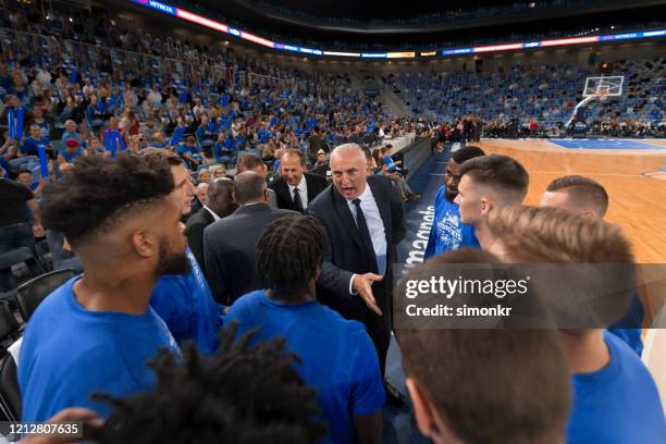 basketball players shaking hands with coach - sports team work stock pictures, royalty-free photos & images