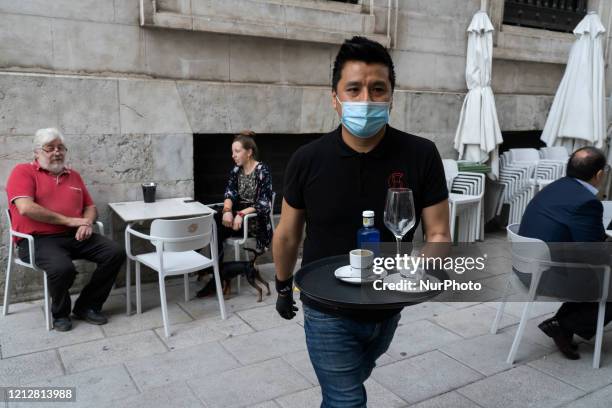 Waiter serves drinks on a terrace of a bar in Santander, Spain, on May 12 which with the arrival of phase 1 of de-escalation, can already open...