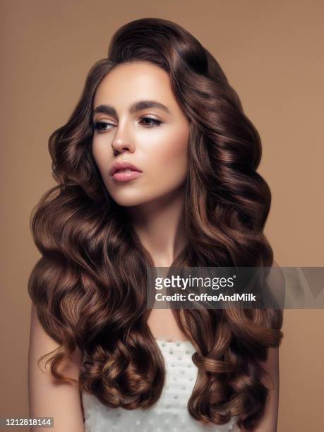 beautiful woman with luxury hair - shiny wavy hair stock pictures, royalty-free photos & images