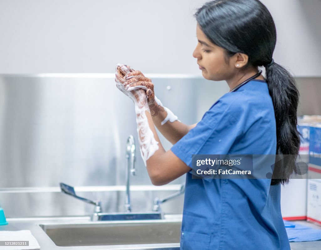 Medical Personnel Hand Washing Dressed in Medical Scrubs stock photo