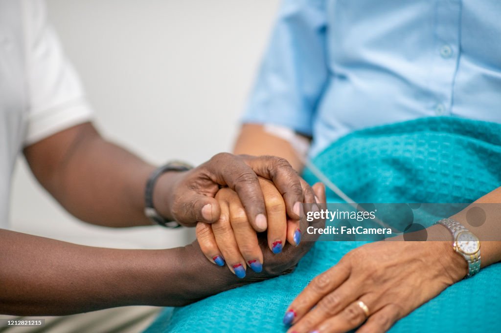 Elderly Patient is Comforted by Medical Personnel stock photo