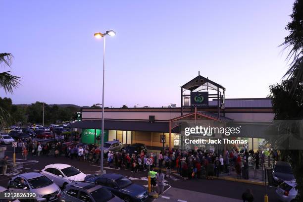 General view outside a Woolworths in Sunbury as people wait outside on March 17, 2020 in Various Cities, Australia. Australian supermarket chains...