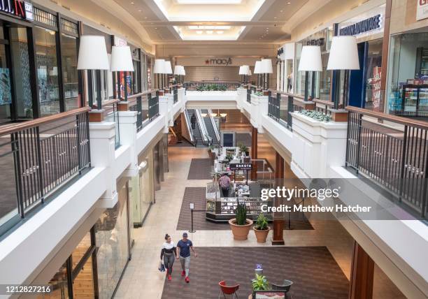Shoppers explore a mostly empty mall where several stores have reopened for the first time since Ohio Governor Mike DeWine's shut down of all...