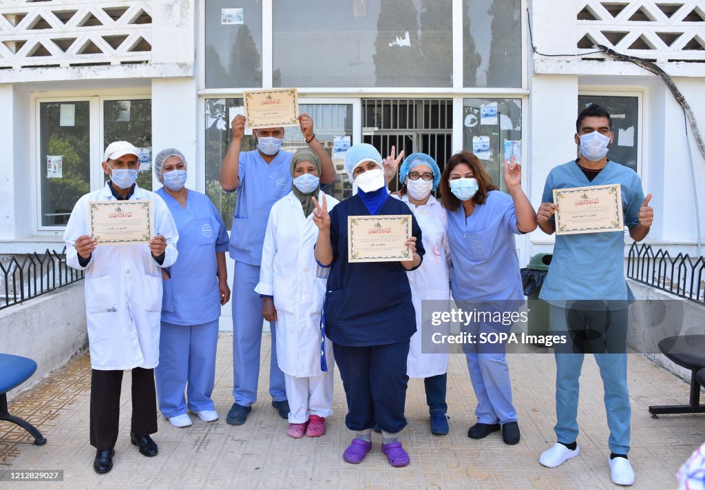 Medical staff pose for a pic with their certificates during...