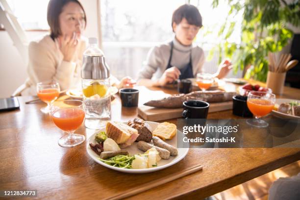 women eating lunch at home party - camel meat stock pictures, royalty-free photos & images